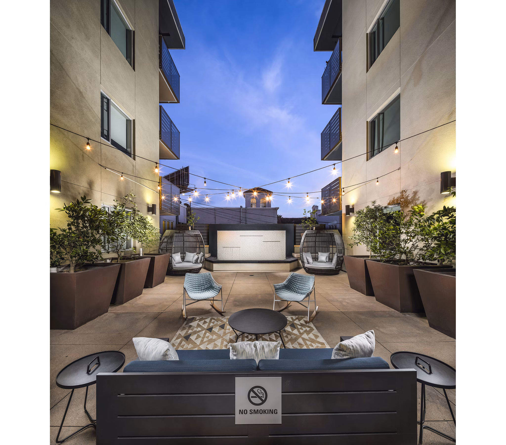 Stylish patio with lush greenery at Alaya Hollywood Apartments, perfect for outdoor relaxation and entertainment