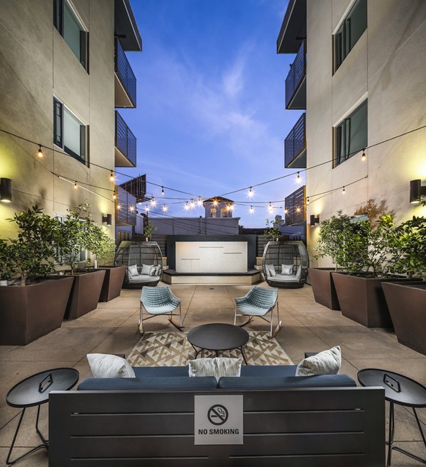 Stylish patio with lush greenery at Alaya Hollywood Apartments, perfect for outdoor relaxation and entertainment