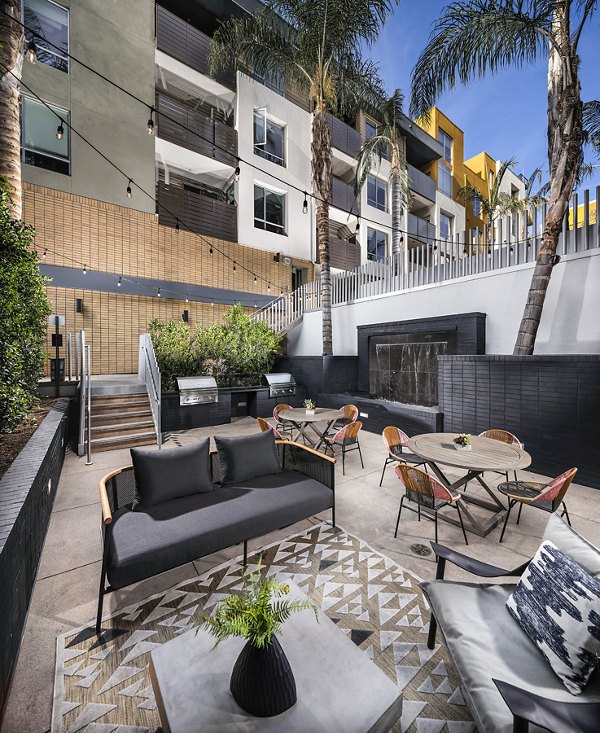 Grill area and patio at Alaya Hollywood Apartments featuring outdoor seating and BBQ stations for entertainment