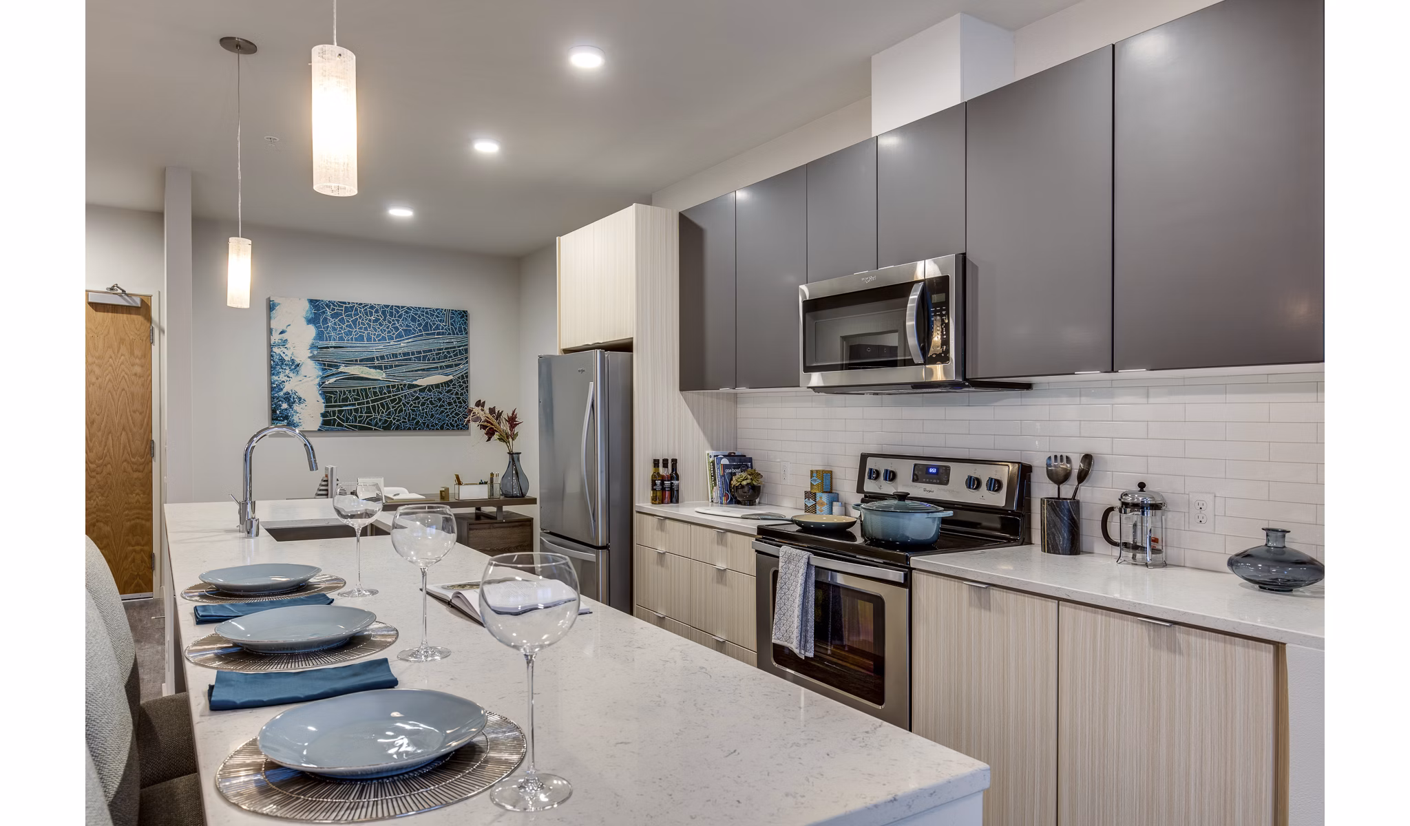 Modern kitchen with stainless steel appliances in Sitka Apartments