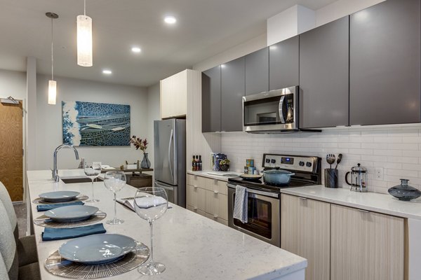 Modern kitchen with stainless steel appliances in Sitka Apartments