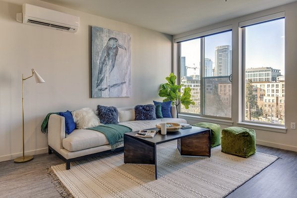 Living room with modern furnishings and natural light in Sitka Apartments