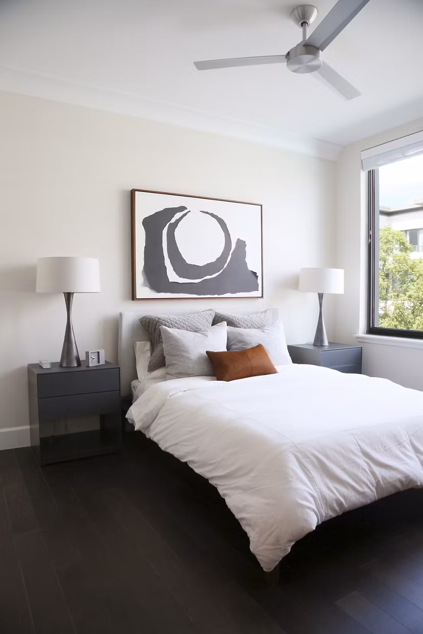 Cozy bedroom featuring modern decor and ample natural light at Grey House Apartments