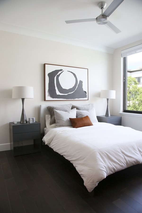 Cozy bedroom featuring modern decor and ample natural light at Grey House Apartments