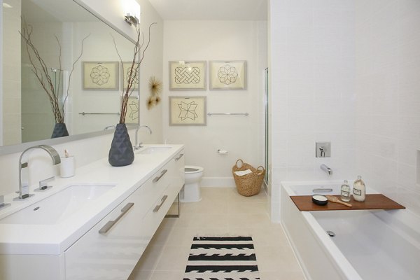 Elegant bathroom with marble countertops and modern fixtures in Grey House Apartments