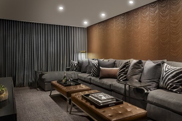 Clubhouse with modern decor at Grey House Apartments featuring seating and entertainment spaces