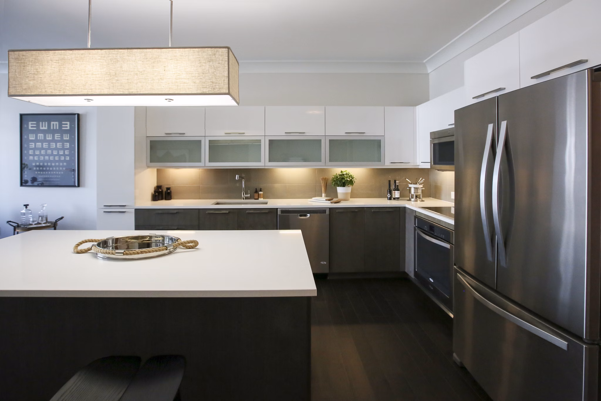 Modern kitchen with stainless steel appliances and island at Grey House Apartments