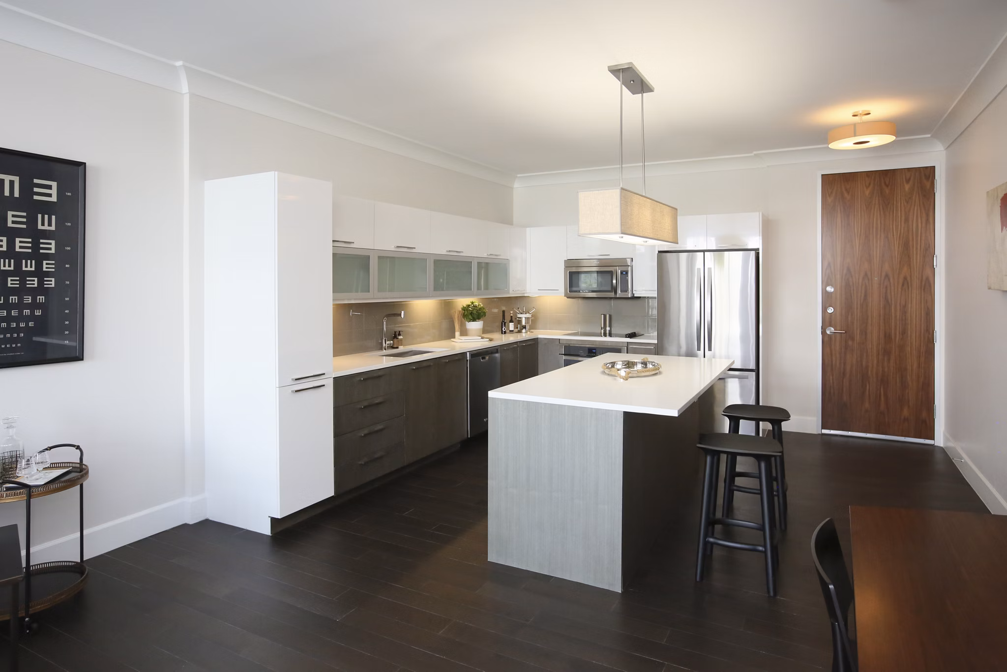 Contemporary kitchen featuring marble countertops and stainless steel appliances in Grey House Apartments