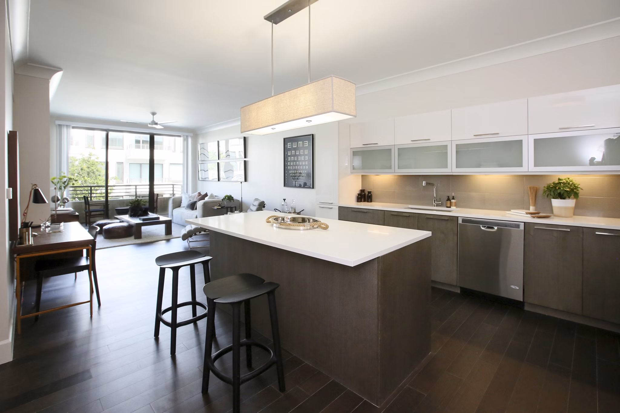 Modern kitchen featuring stainless steel appliances and granite countertops at Grey House Apartments