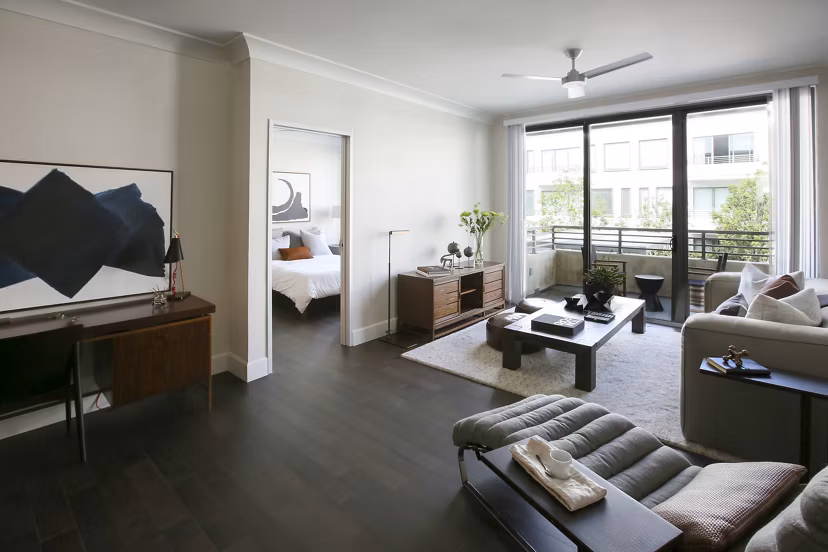 Modern living room with elegant decor and natural light at Grey House Apartments