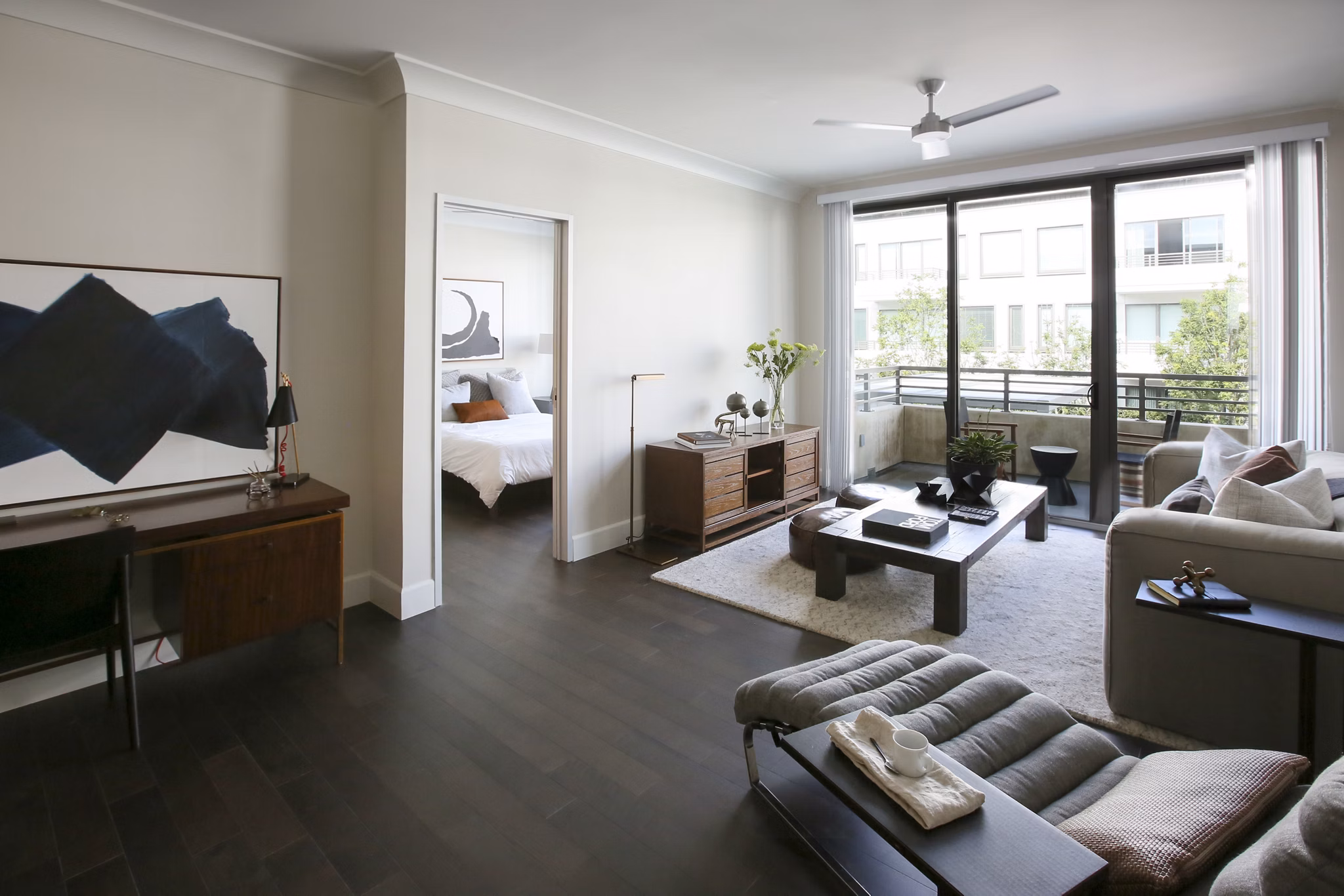Modern living room with elegant decor and natural light at Grey House Apartments