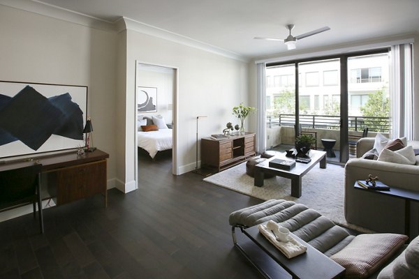 Modern living room with elegant decor and natural light at Grey House Apartments