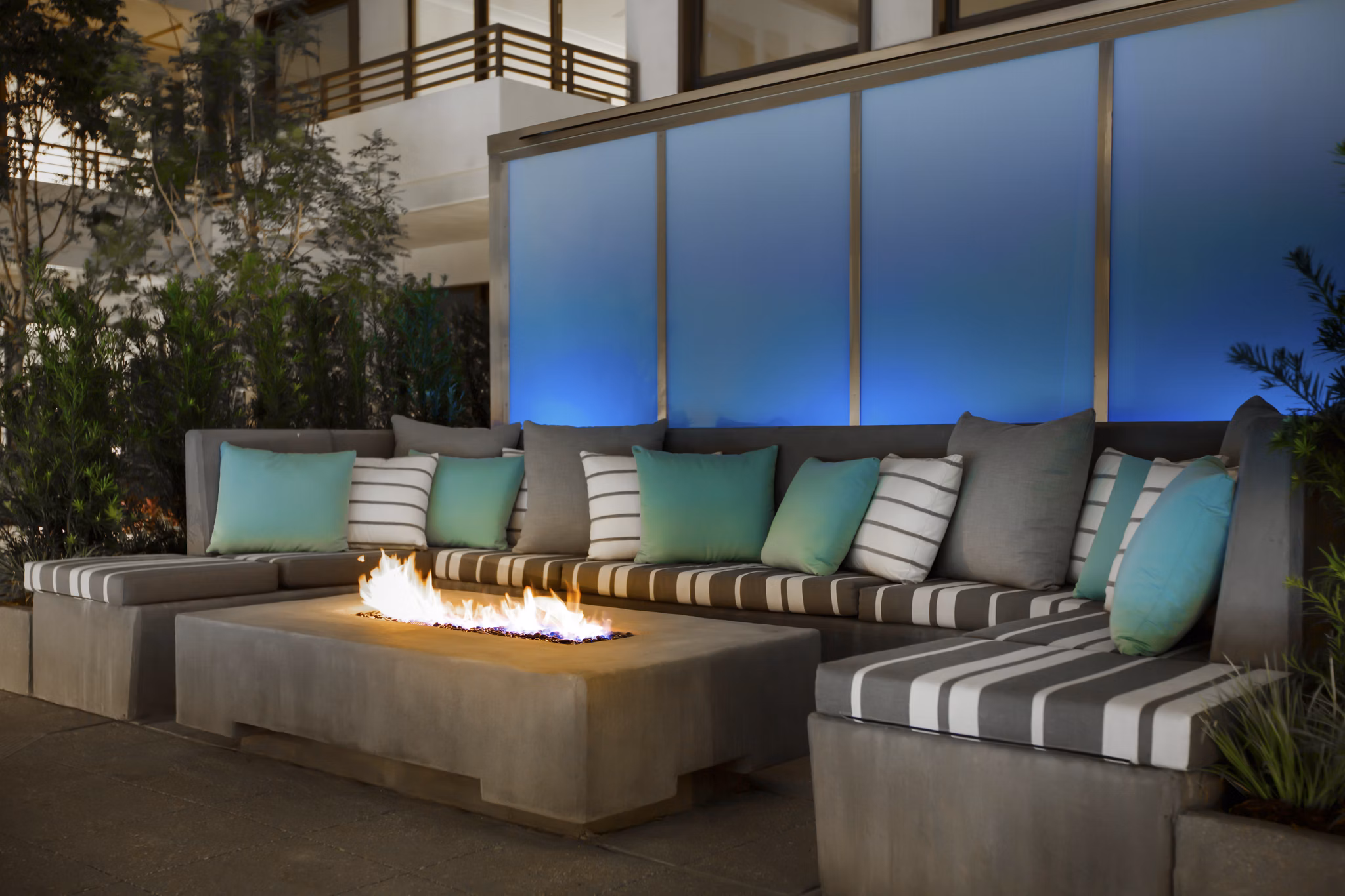 Fire pit lounge area at Grey House Apartments offering cozy outdoor seating and ambiance for residents