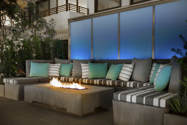 Fire pit lounge area at Grey House Apartments offering cozy outdoor seating and ambiance for residents