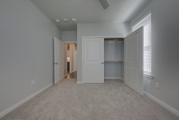 Modern bedroom with stylish decor at Tacara Westpointe Village Apartments