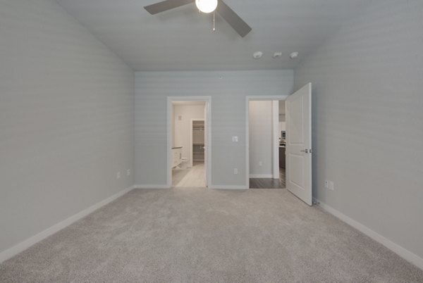 Modern bedroom with elegant decor at Tacara Westpointe Village Apartments