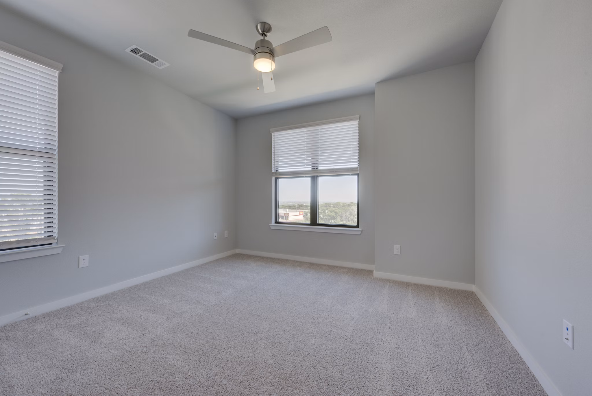 Cozy bedroom with modern furnishings at Tacara Westpointe Village Apartments, offering luxury living near San Antonio