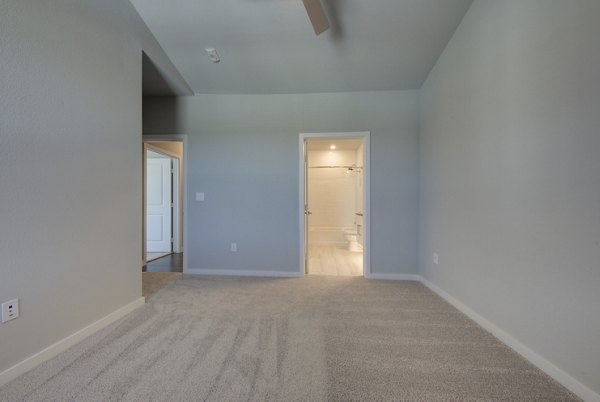 Modern bedroom with sleek decor at Tacara Westpointe Village Apartments