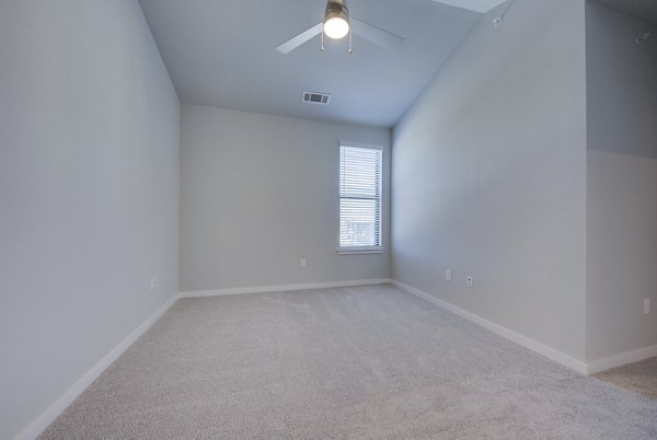 Bedroom featuring elegant decor and plush bedding at Tacara Westpointe Village Apartments