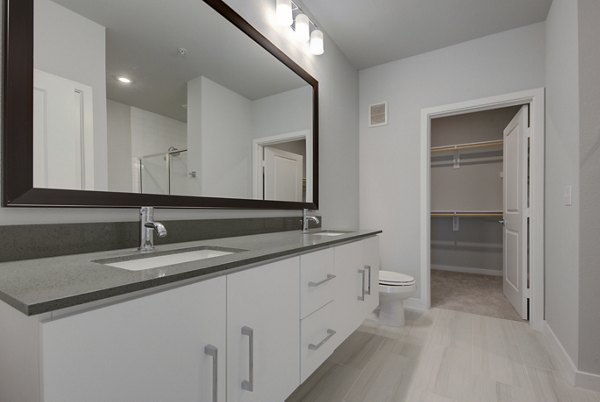 Modern bathroom with sleek fixtures and spacious countertops in Tacara Westpointe Village Apartments