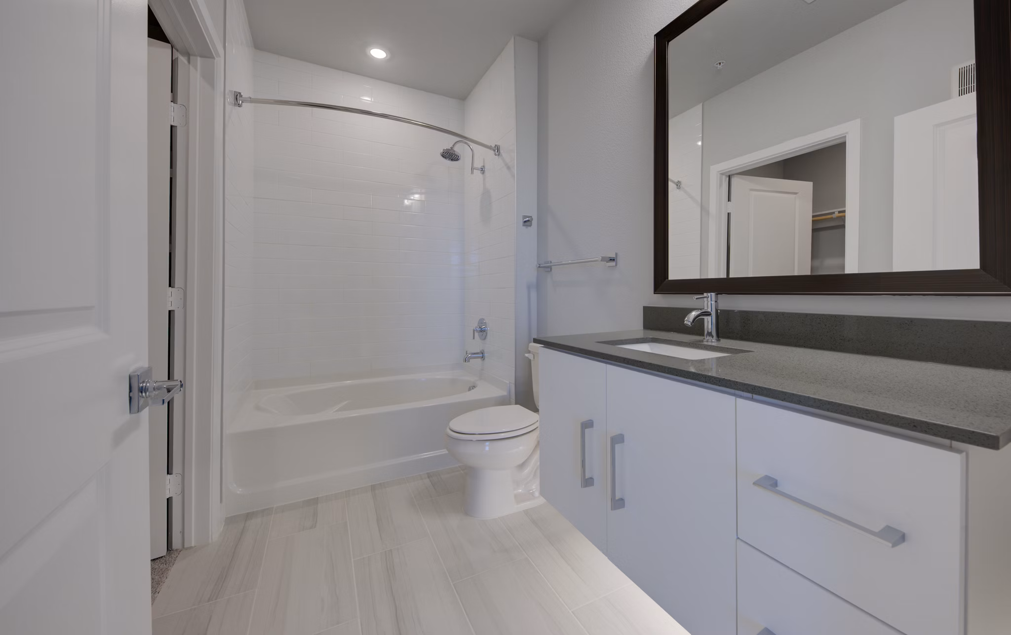 Bathroom with modern fixtures and granite countertops at Tacara Westpointe Village Apartments