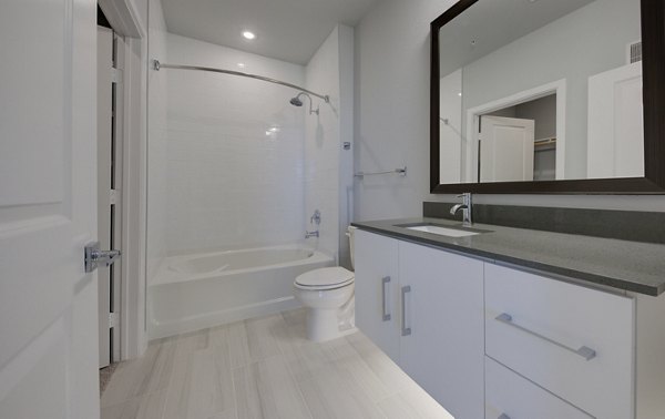 Bathroom with modern fixtures and granite countertops at Tacara Westpointe Village Apartments