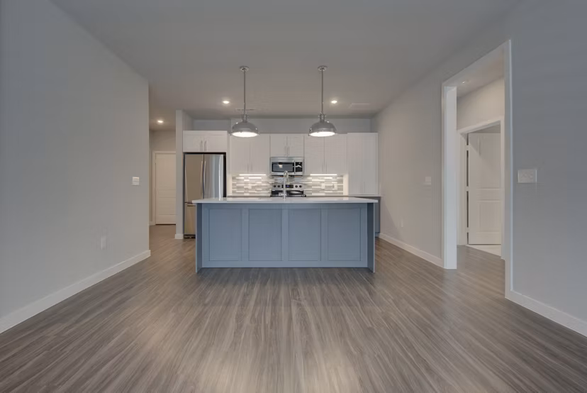 Open-concept kitchen with granite countertops in Tacara Westpointe Village Apartments