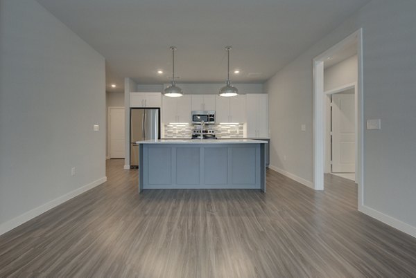 Open-concept kitchen with granite countertops in Tacara Westpointe Village Apartments