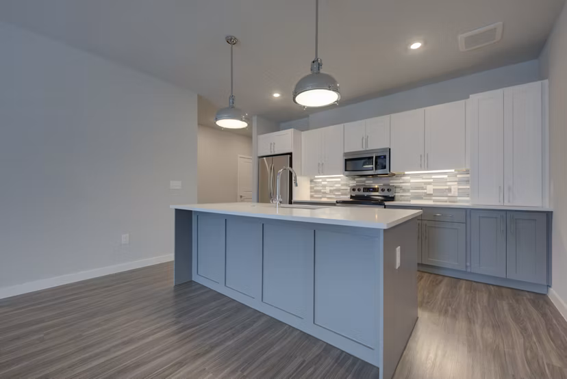 Modern kitchen with stainless steel appliances at Tacara Westpointe Village Apartments in a luxury Greystar community