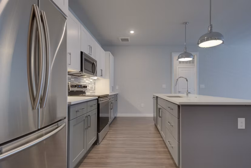 Modern kitchen featuring stainless steel appliances and granite countertops at Tacara Westpointe Village Apartments