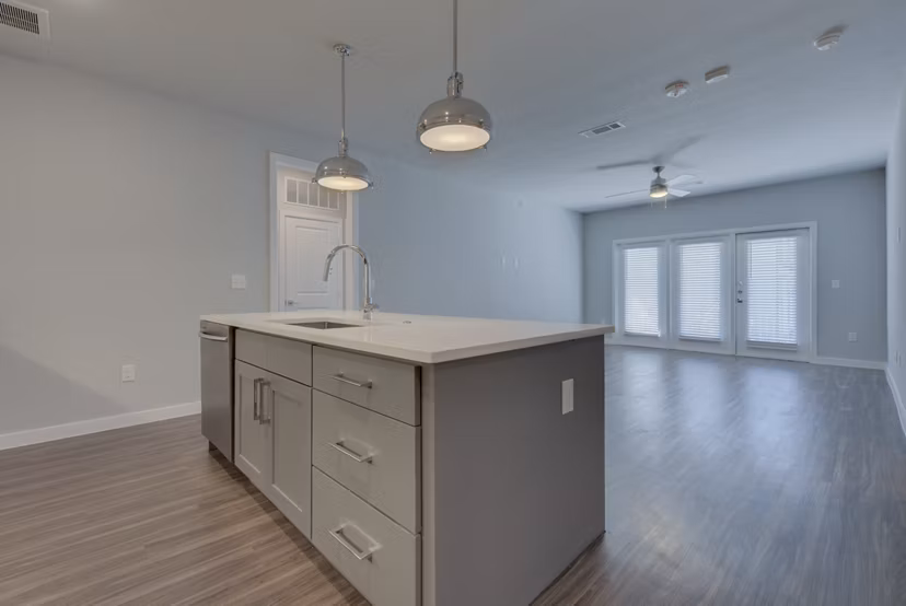 Modern kitchen featuring granite countertops and stainless steel appliances in Tacara Westpointe Village Apartments