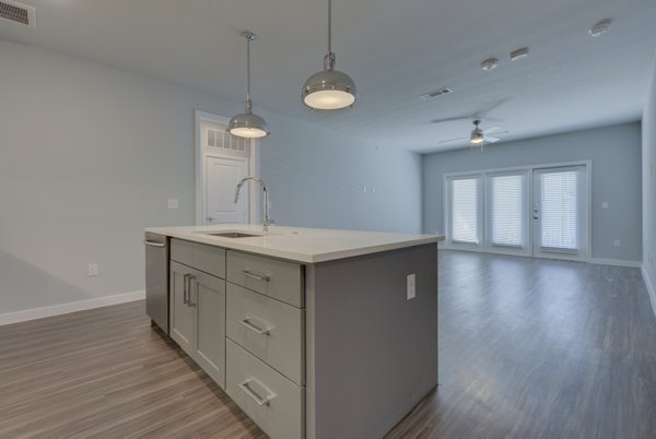 Modern kitchen featuring granite countertops and stainless steel appliances in Tacara Westpointe Village Apartments