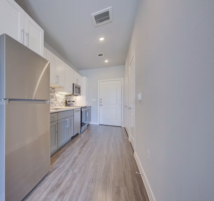 Modern kitchen with stainless steel appliances in Tacara Westpointe Village Apartments