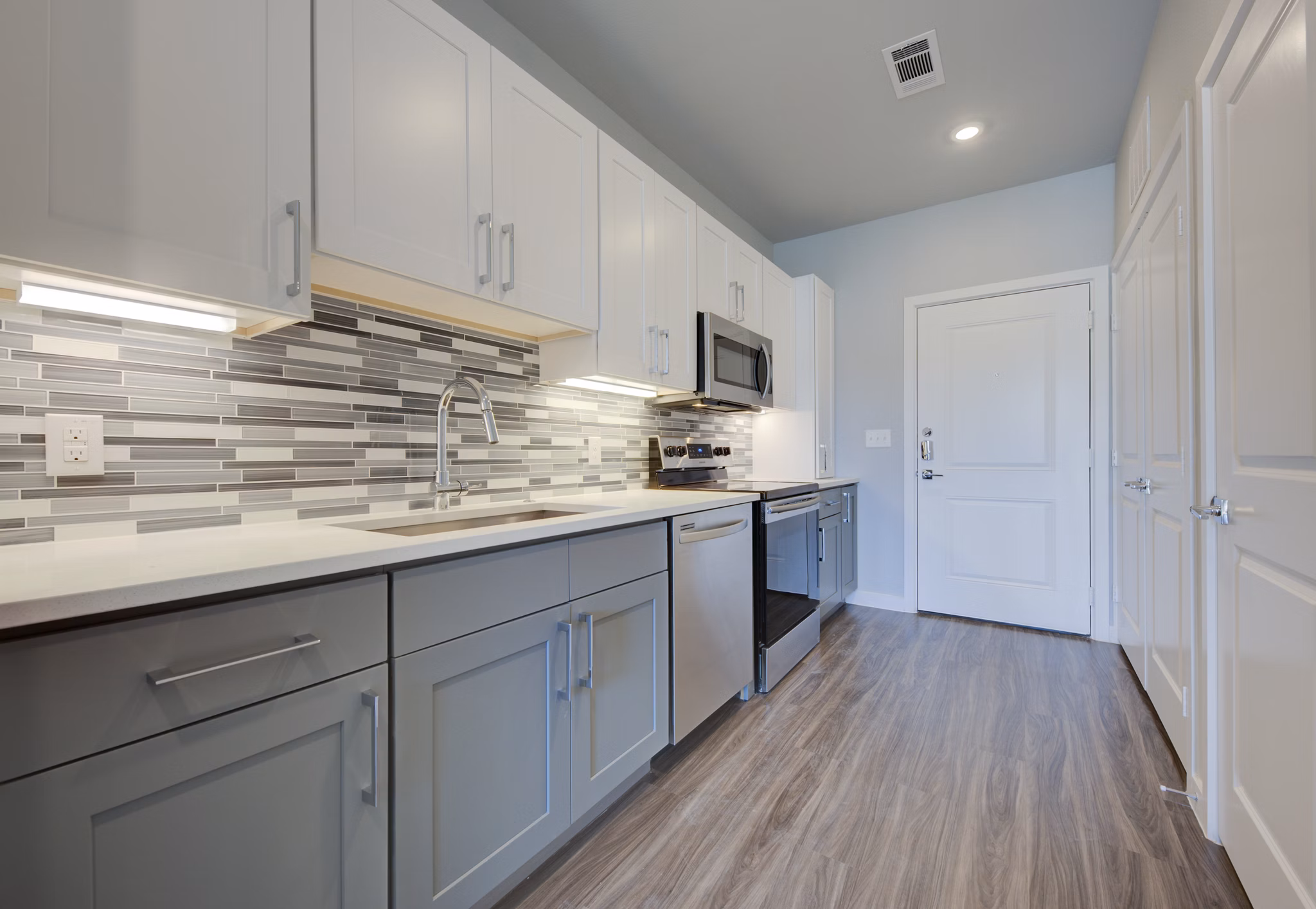 Modern kitchen featuring stainless steel appliances in Tacara Westpointe Village Apartments