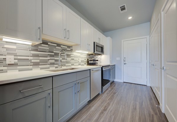Modern kitchen featuring stainless steel appliances in Tacara Westpointe Village Apartments