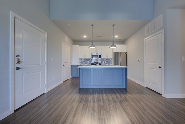 Modern kitchen with stainless steel appliances at Tacara Westpointe Village Apartments