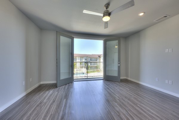 Cozy living room with modern decor at Tacara Westpointe Village Apartments, featuring luxurious seating and natural lighting