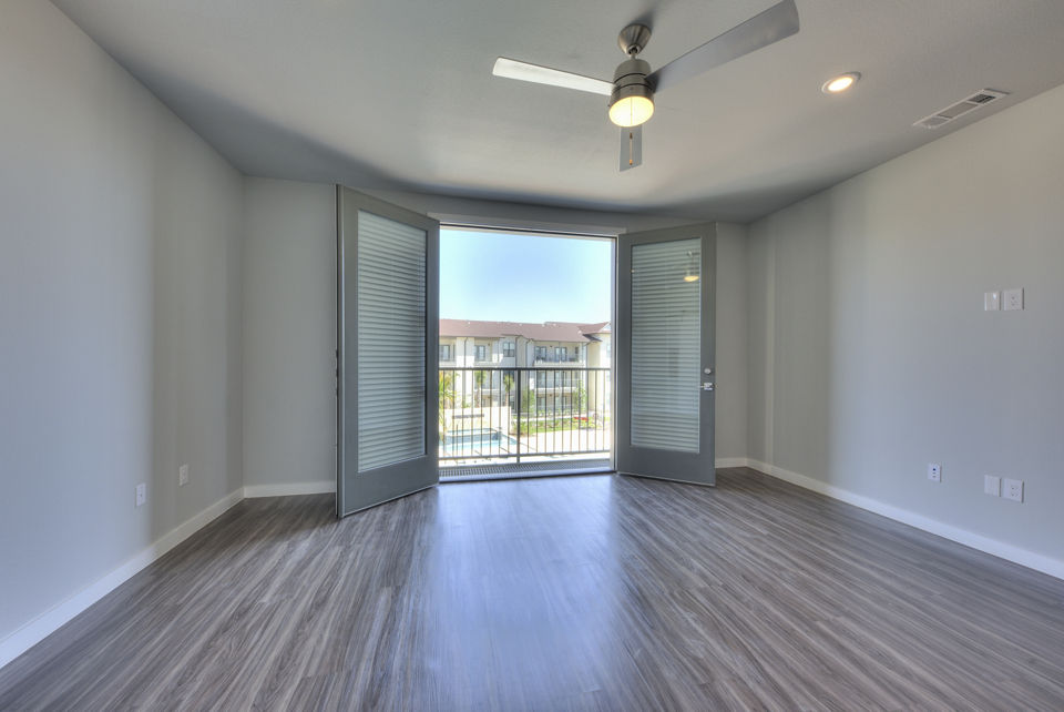 Cozy living room with modern decor at Tacara Westpointe Village Apartments, featuring luxurious seating and natural lighting