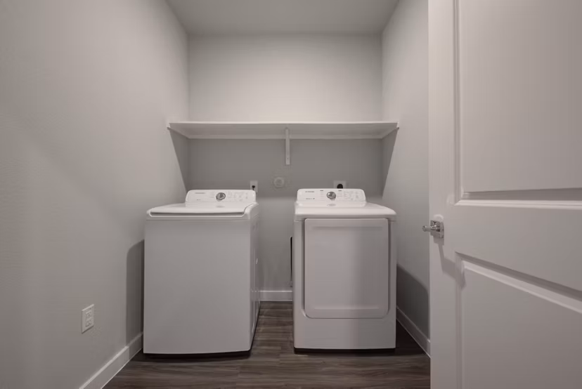 Modern laundry room with sleek appliances in Tacara Westpointe Village Apartments