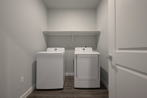 Modern laundry room with sleek appliances in Tacara Westpointe Village Apartments