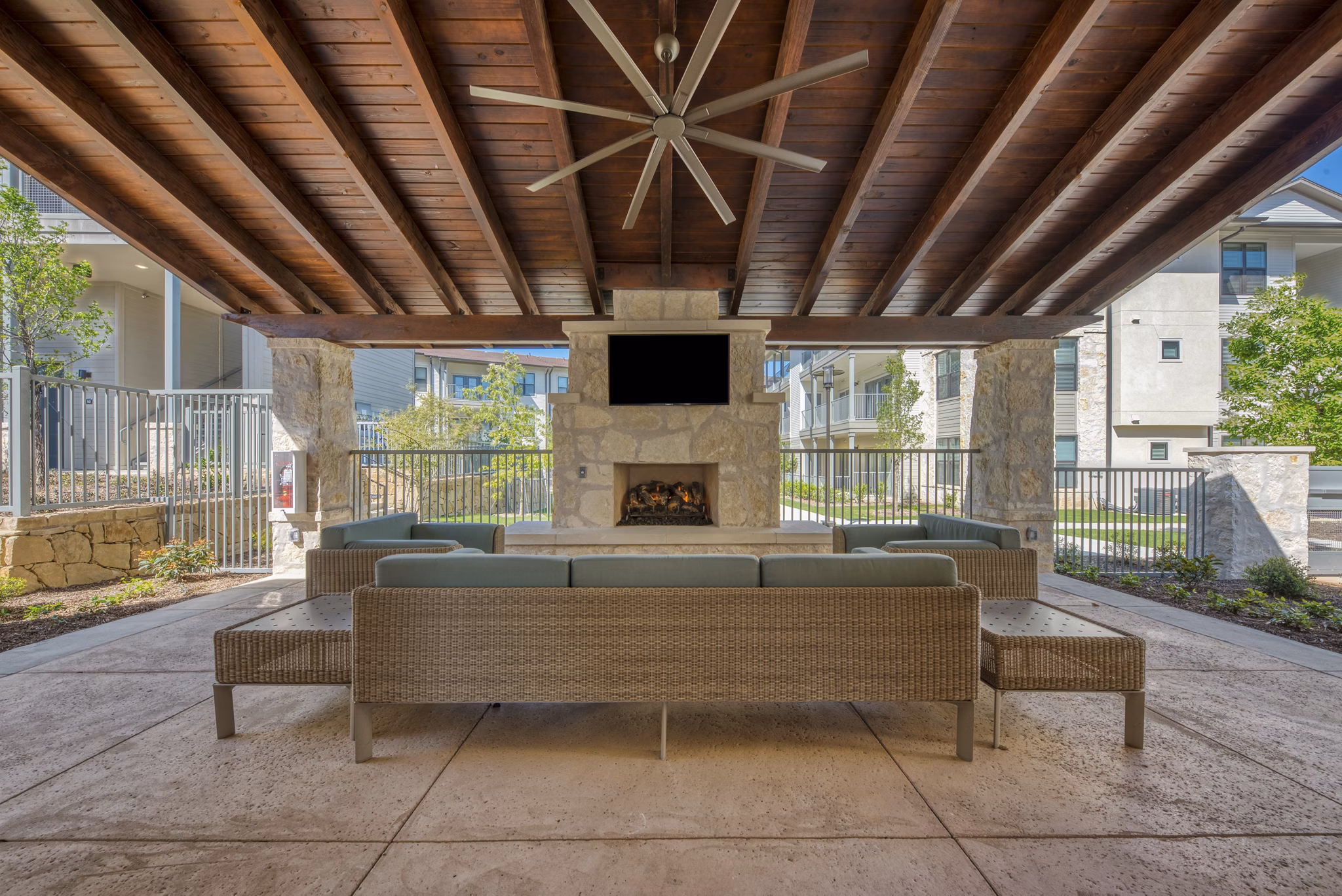 Modern patio space with comfortable seating and greenery at Tacara Westpointe Village Apartments