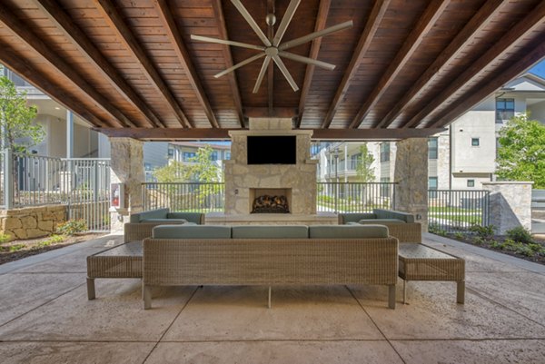 Modern patio space with comfortable seating and greenery at Tacara Westpointe Village Apartments