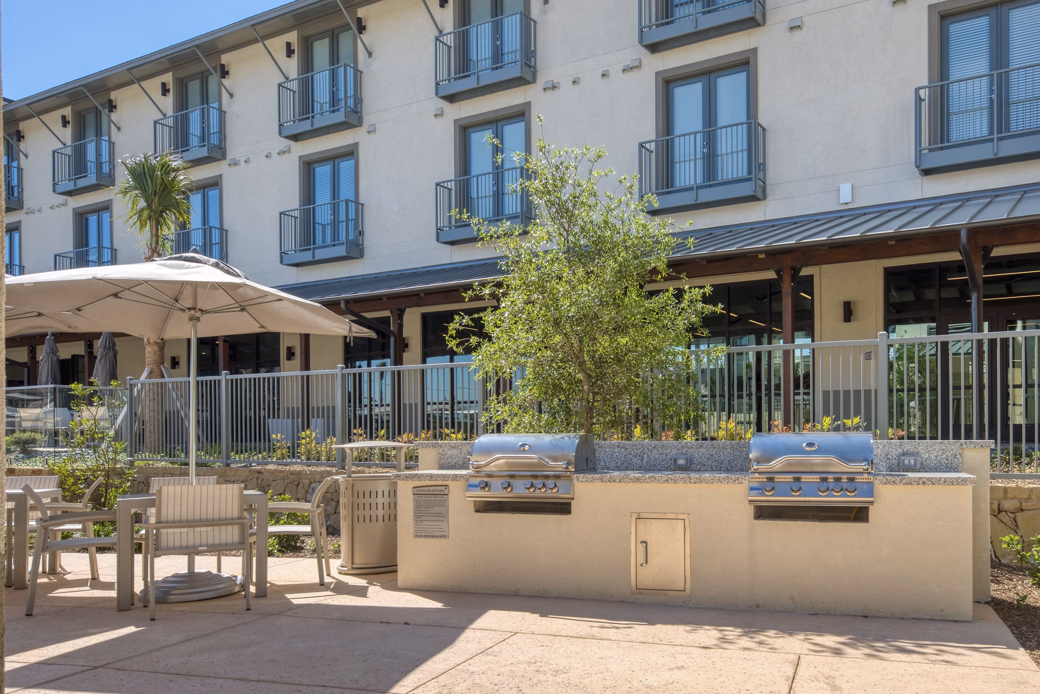 Outdoor grill area with seating at Tacara Westpointe Village Apartments