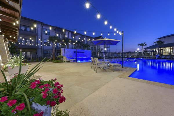 Outdoor patio with cozy seating at Tacara Westpointe Village Apartments