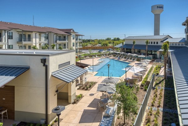 Tacara Westpointe Village: Scenic views of luxury apartments amid lush landscaping in New Braunfels, perfect for modern living