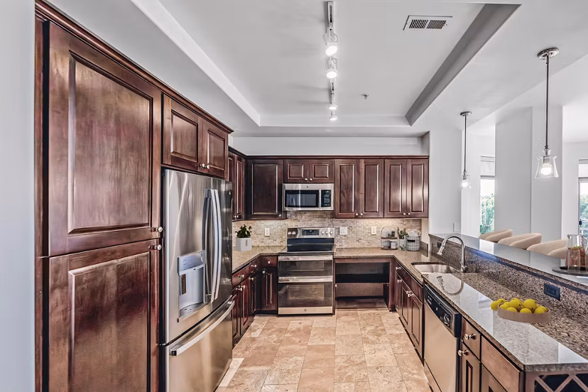 Modern kitchen with sleek appliances and quartz countertops at The Residence at SouthPark Apartments