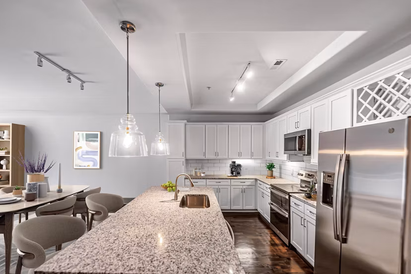 Modern kitchen featuring stainless steel appliances and sleek countertops in The Residence at SouthPark Apartments