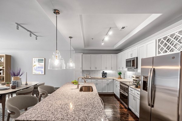 Modern kitchen featuring stainless steel appliances and sleek countertops in The Residence at SouthPark Apartments