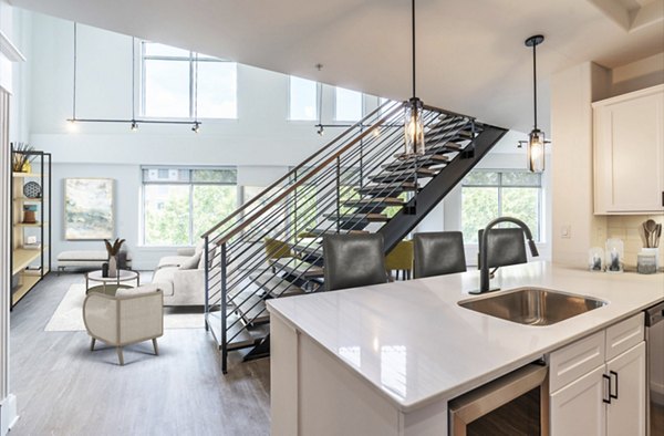 Modern kitchen with stainless steel appliances at The Residence at SouthPark Apartments