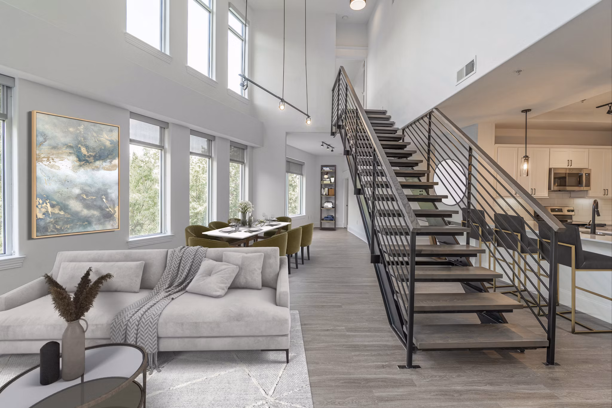 Living room with modern decor and large windows at The Residence at SouthPark Apartments
